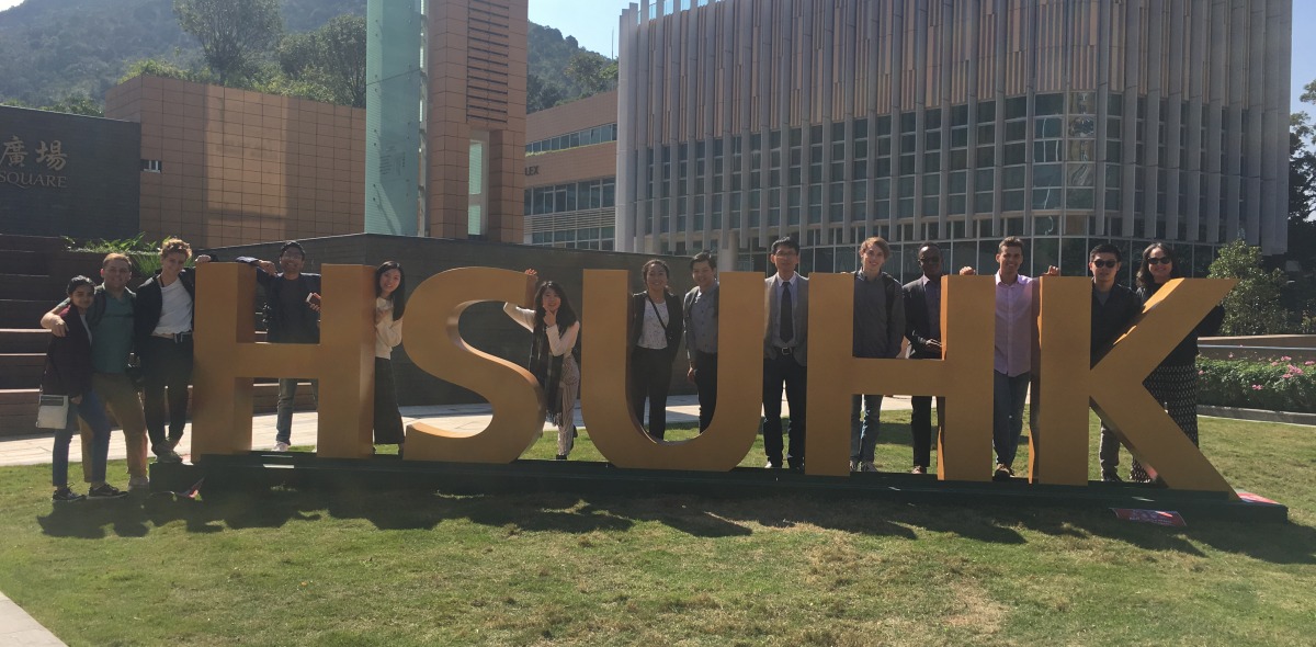 Image of students posing with a large sign in Hong Kong.