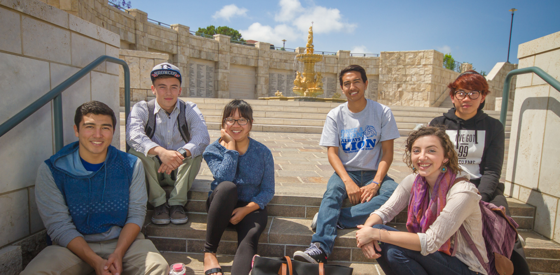 Image of students sitting in front of the Peace Lake fountain.