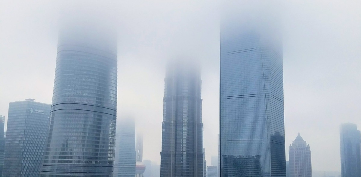 Skyscrapers fading into a thick cloud of smog. 