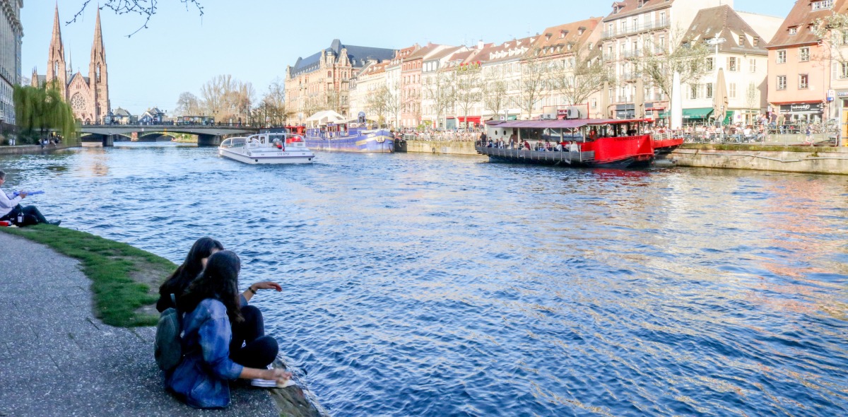 Image of students sitting and looking at water