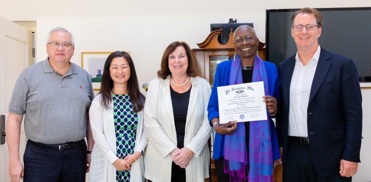 Image of four faculty members posing with Roxane Cohen.