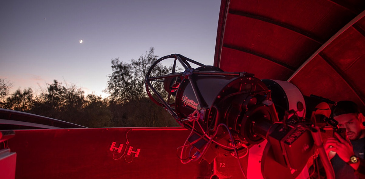 Student looks through telescope 