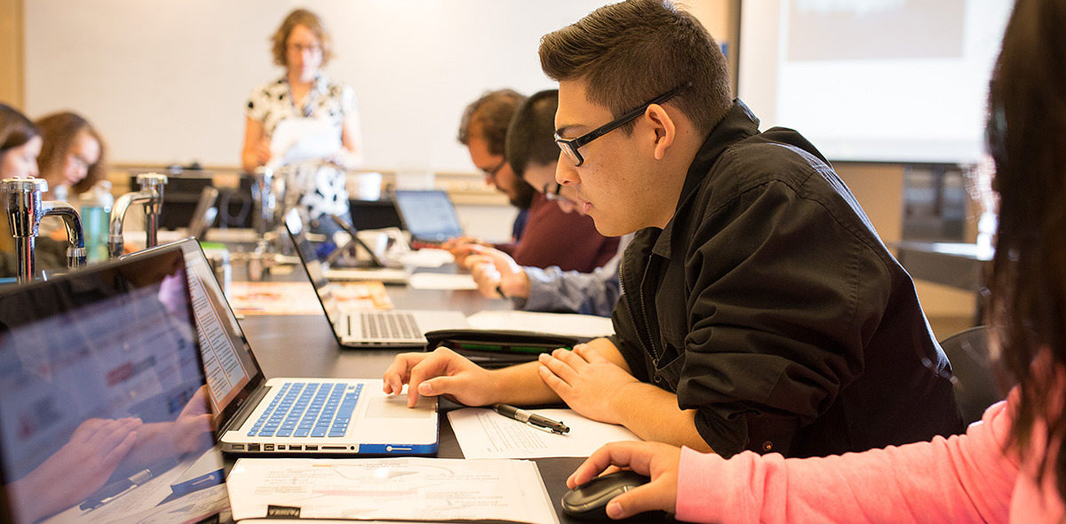 Students working on laptops in Pauling Hall classroom