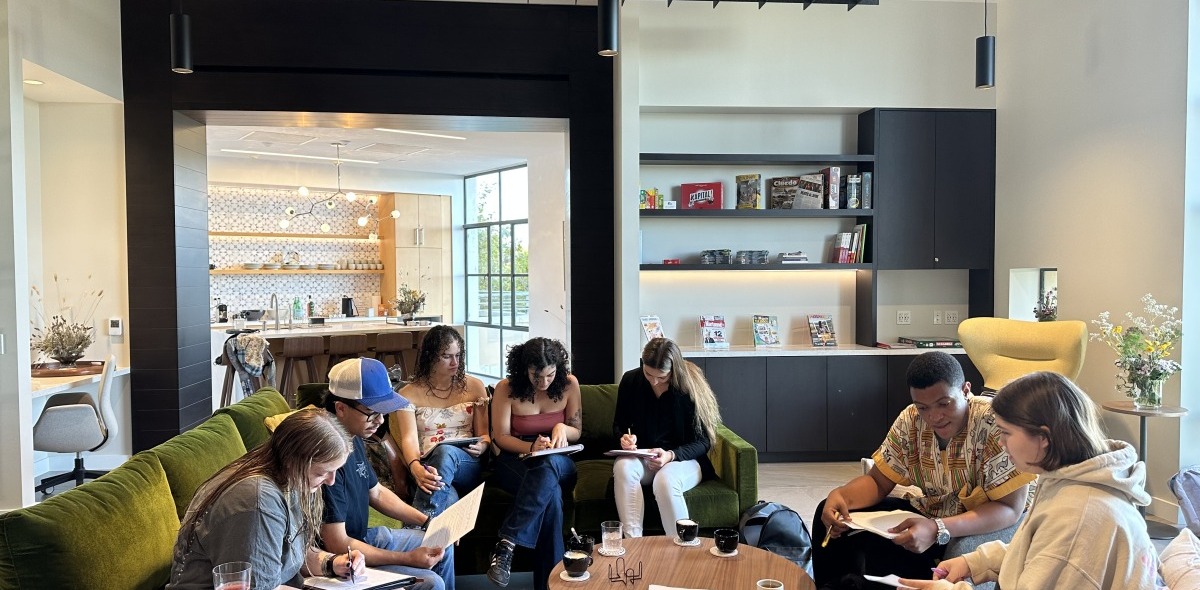 A large group of students sit together in the Global Language and Culture Center