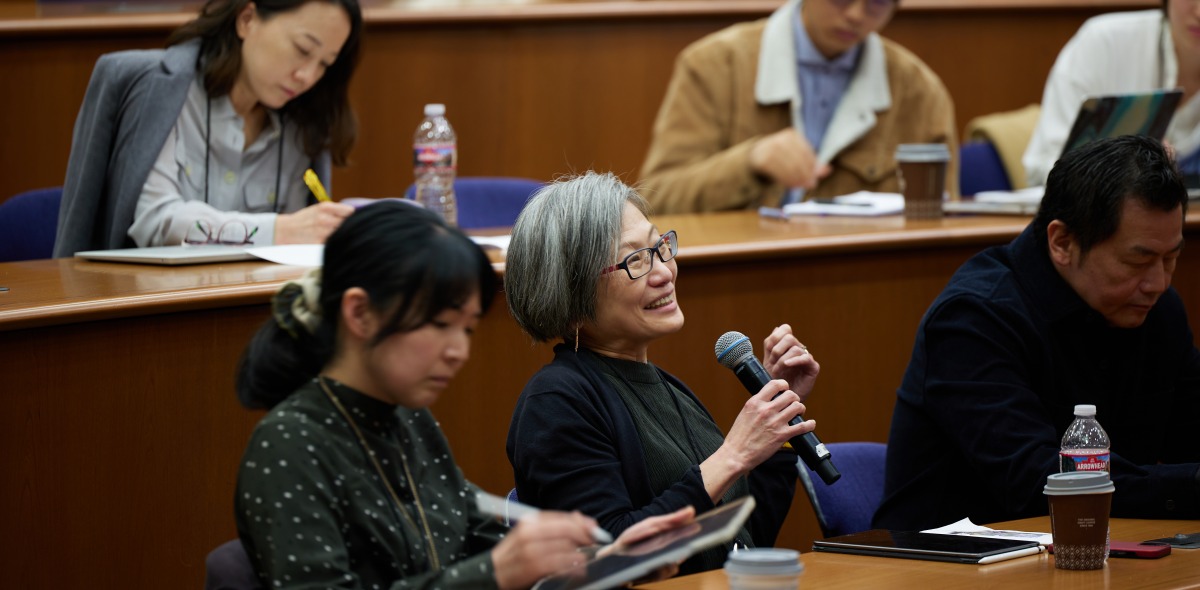 A participant of the SIGS Symposium asks a question to the panel of speakers in Pauling 216