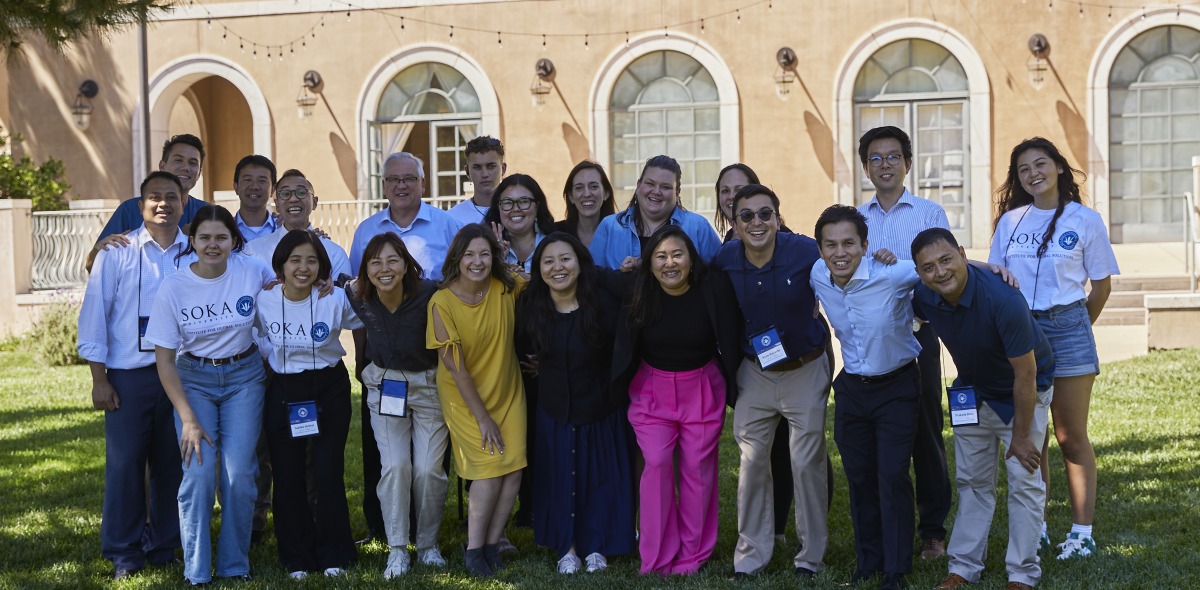 Attendees of the conference pose for a group photo on SUA's campus
