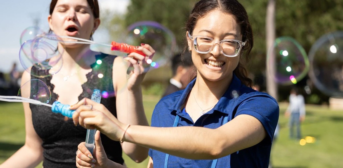 Students playing with bubbles