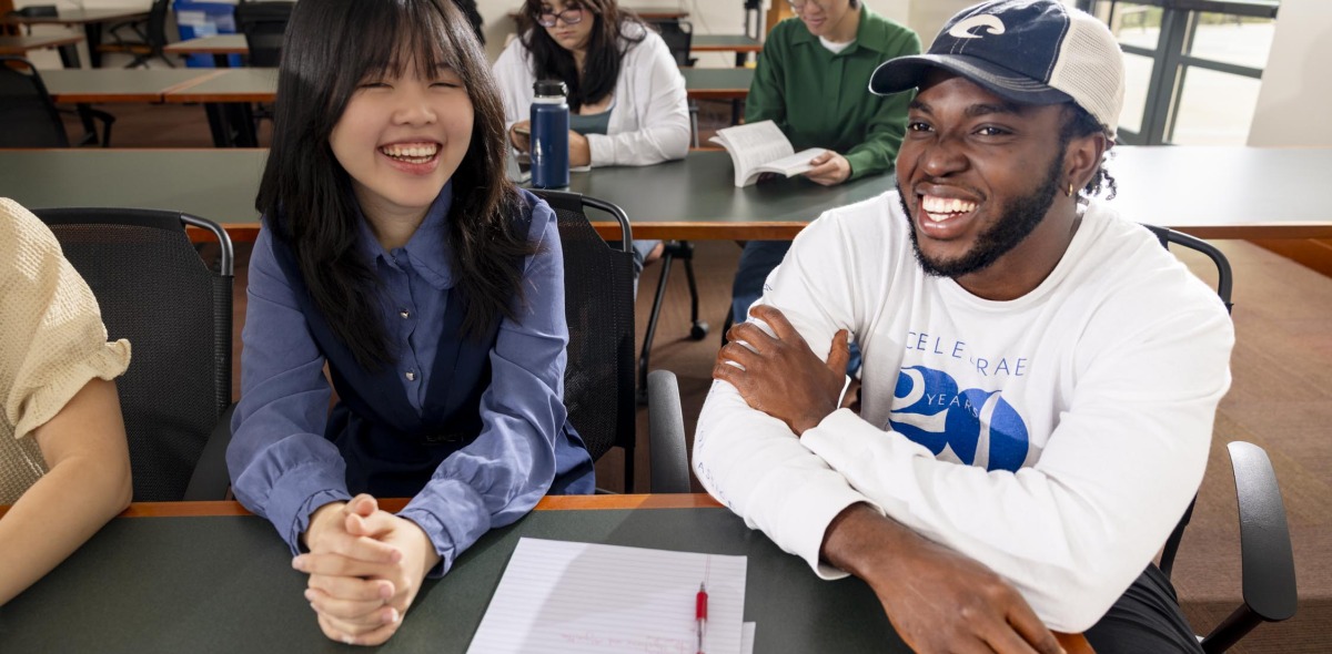 Students smile in the classroom.