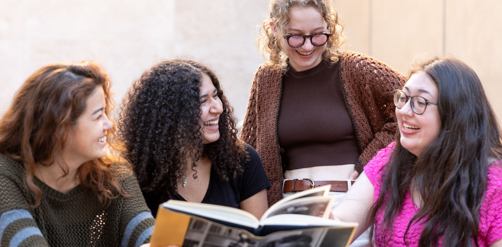Students talking over a book