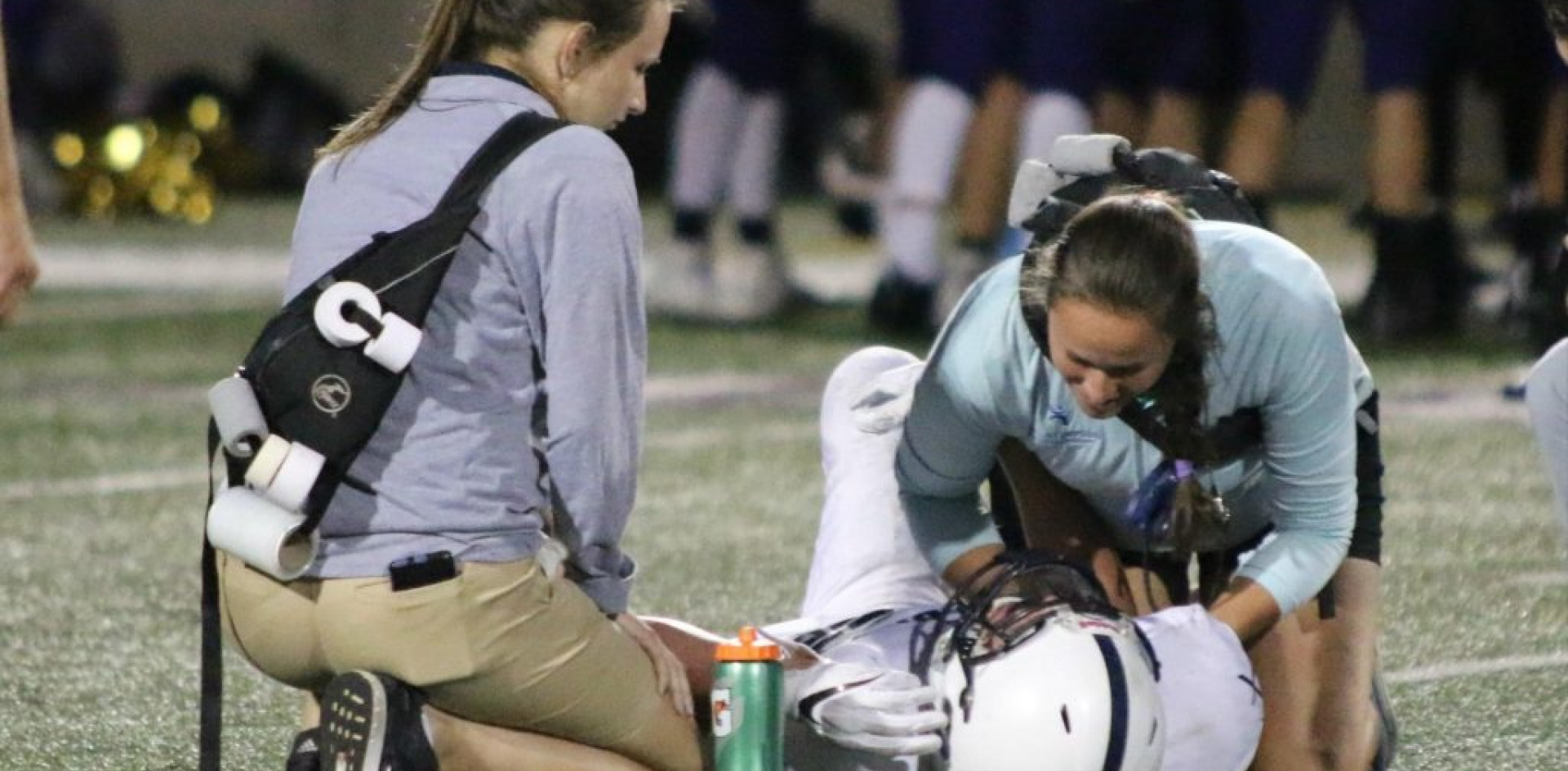 athletic trainers helping an athlete during the match