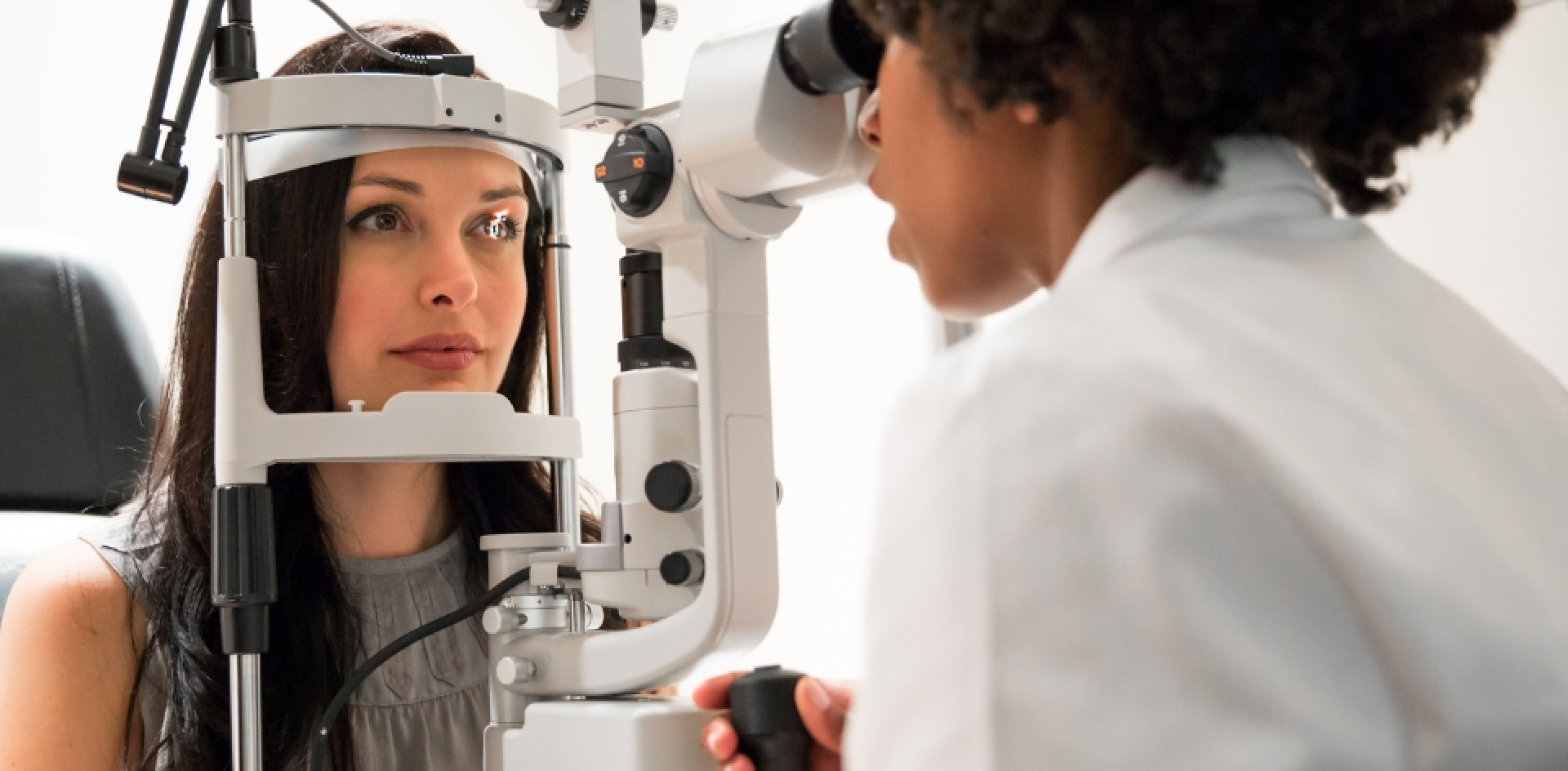 Optomist performing examination for a woman