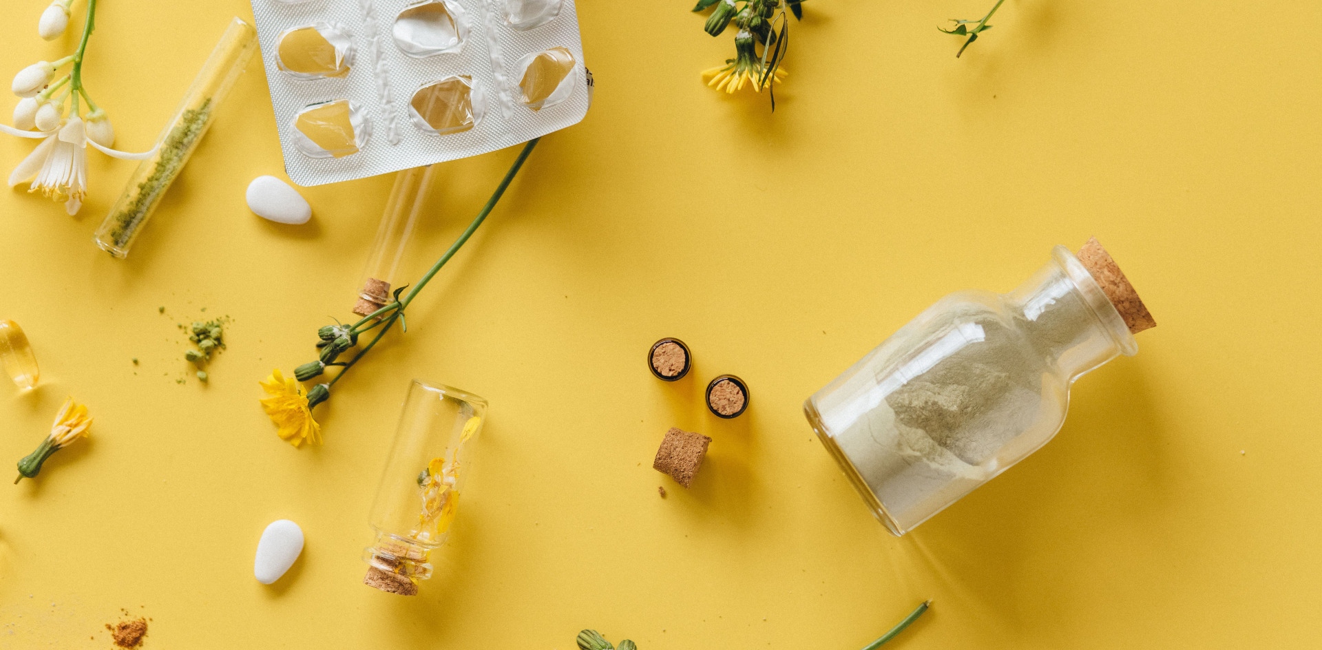 Flat lay of herbal medicines and glass containers