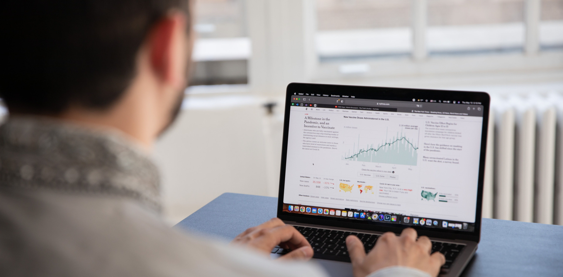 A person working on a laptop analyzing health data 