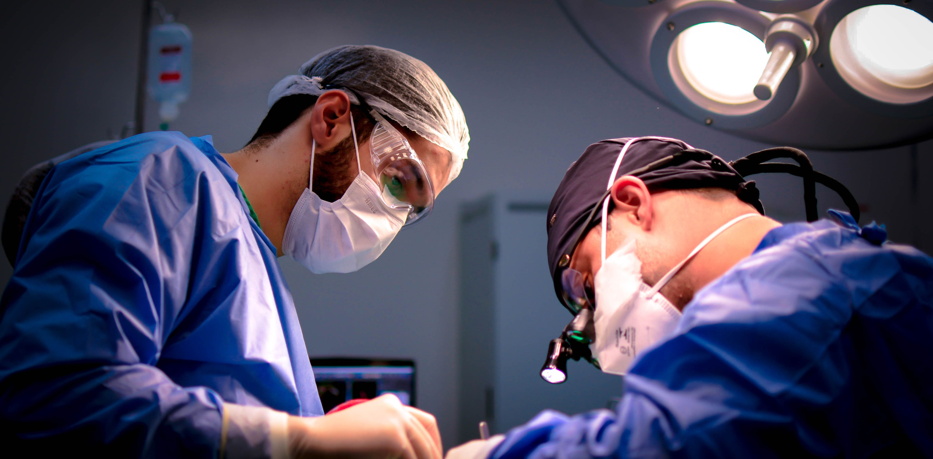 Focused surgeons performing a meticulous operation in a hospital operating room