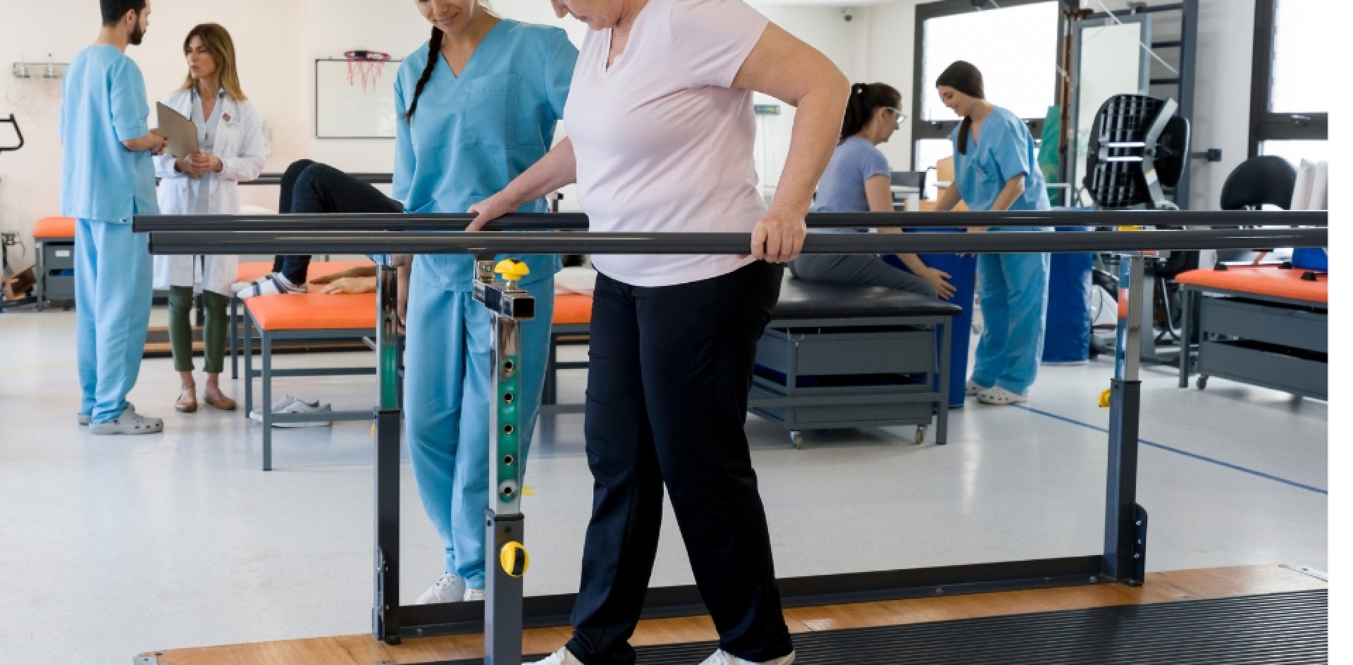 A PT helping a woman walking between parallel lines during a sesion