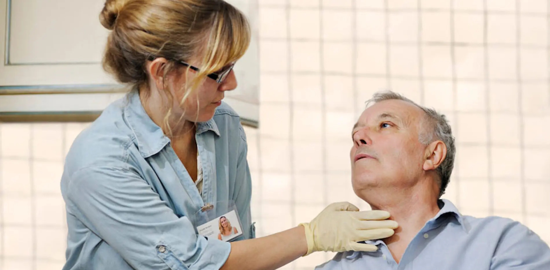 A speech-language pathologist examining an elder's speech ability