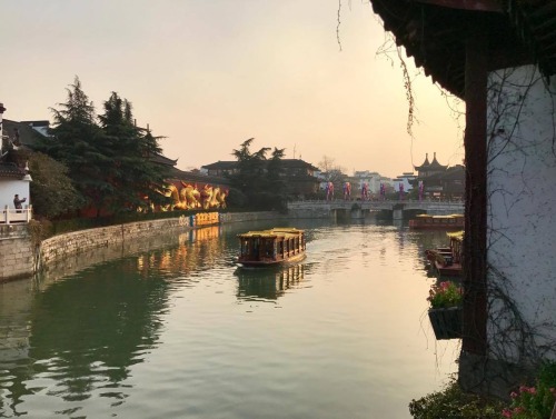 Buildings on either side of a river in Nanjing, China