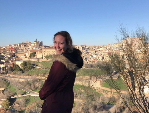 Student looking over her shoulder in park in Granada