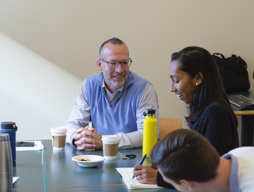 Tom Dodd sitting with Maya Gunaseharan