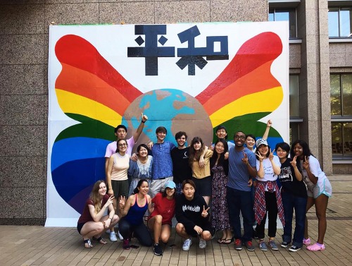 Students in front of rainbow mural in Japan