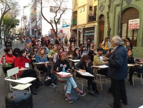 Students at tables on street in Buenos Aires