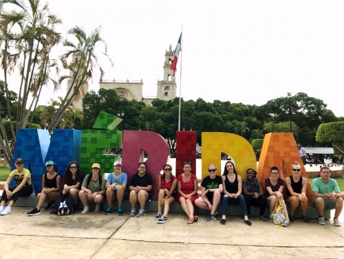 Students in front of letters spelling out Merida