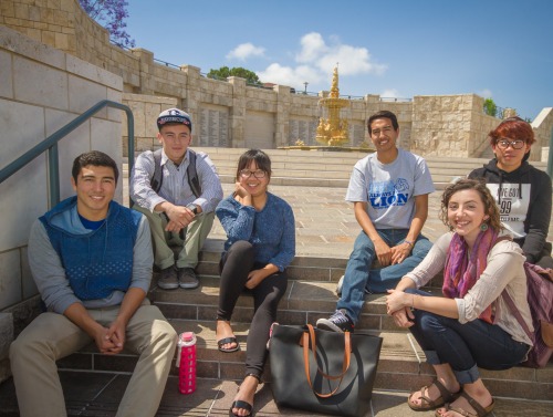 Image of students sitting in front of the Peace Lake fountain.