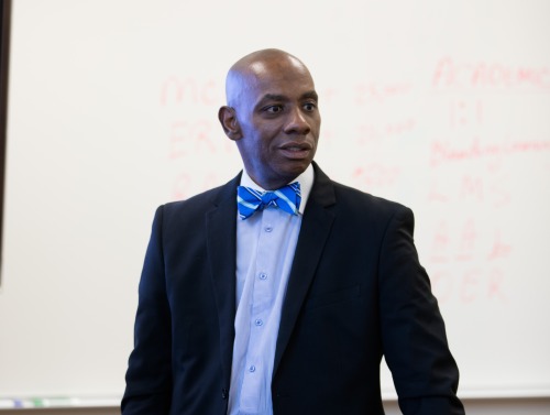 Anthony D. Jackson standing in front of a whiteboard