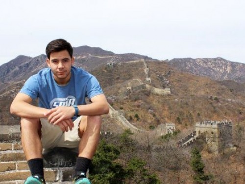 Student sitting on Great Wall of China