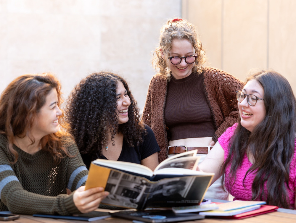 Students talking over a book