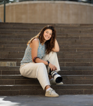 Marina Inoue poses with a camera on SUA's campus
