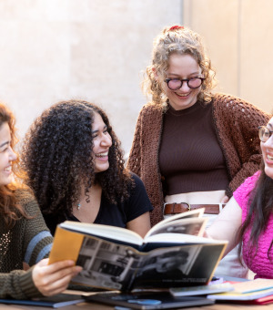 Students talking over a book
