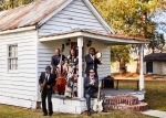 Artists sitting on porch of house