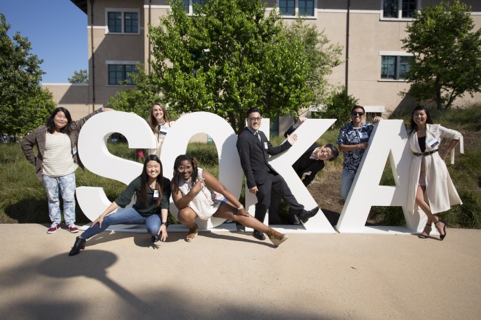 Alumni around Soka sign