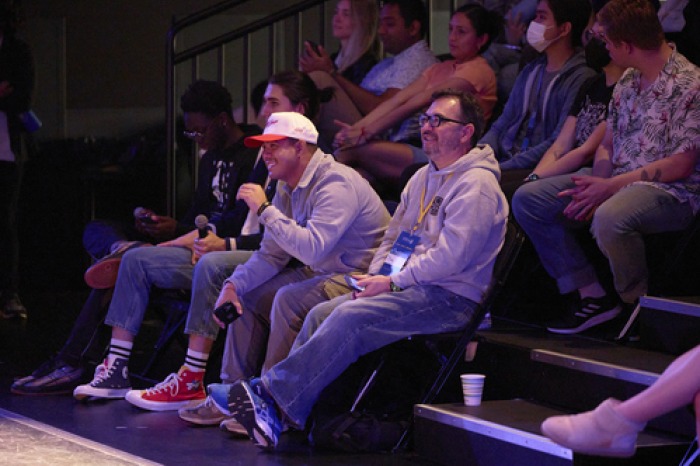 Students and staff laugh in the Black Box Theatre