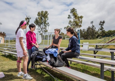 Image of students chatting by the track.