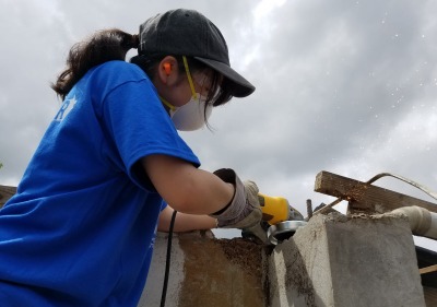 student working to rebuild house