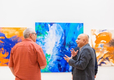 Image of two visitors discussing at the art gallery.
