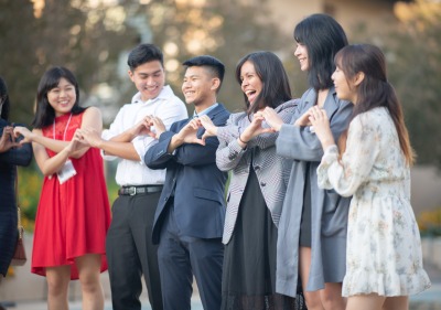 Image of students making hearts with their hands