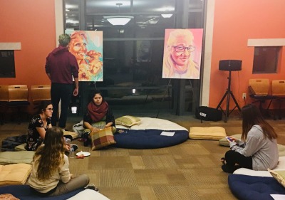 Students from Hope in Action looking at artwork.