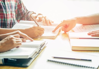 Tutor helping student with writing