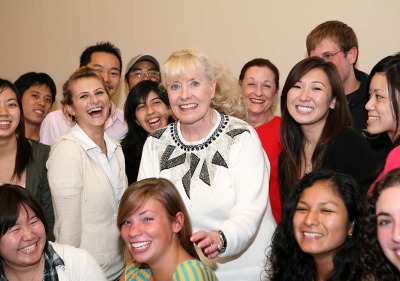 Betty Williams surrounded by SUA students