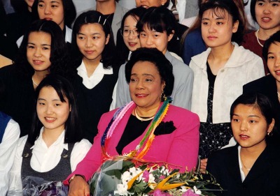 Coretta Scott King surrounded by Soka students