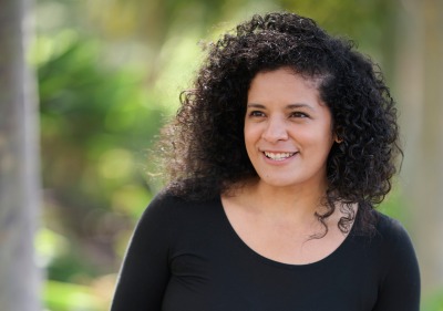 Jacqueline Cid poses outside wearing a black shirt for the Women of SUA photoshoot