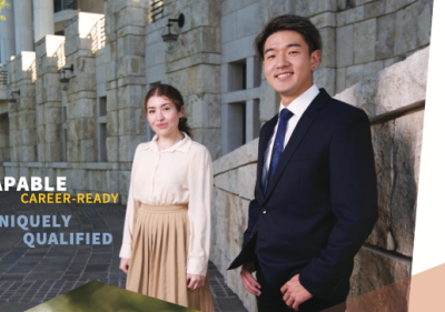 Two Soka students dressed in career attire standing outside Founders Hall