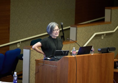 A female speaker presents during the symposium