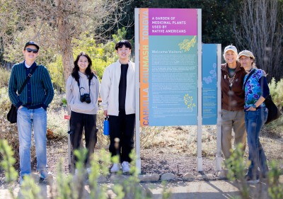 A small group of undergraduate students from the "Geo-storytelling Ballona" Learning Cluster pose at the Ballona Wetlands