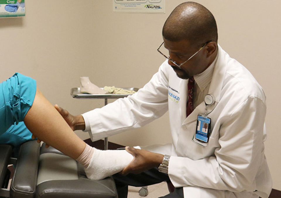 A doctor examining the patient's foot and ankle