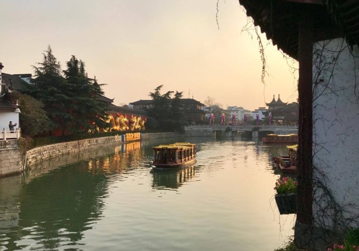 Buildings on either side of a river in Nanjing, China