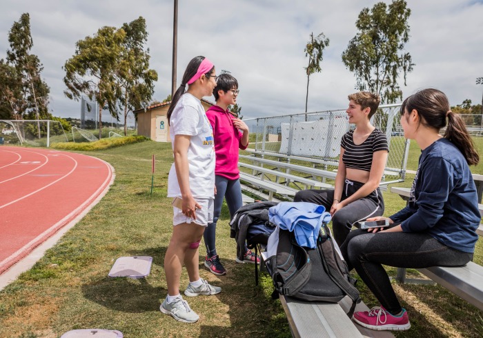 Image of students talking alongside the track.